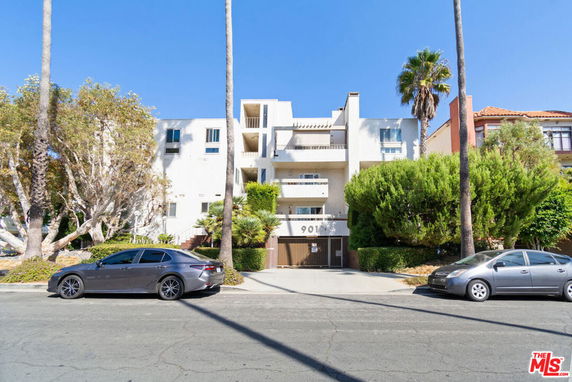 Front view of a multi-story modern apartment building with balconies.