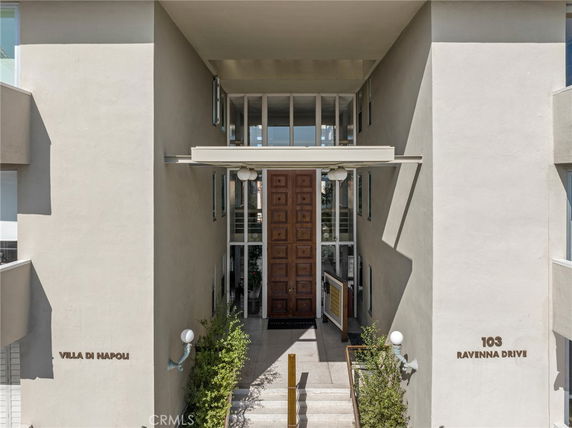 Front view of a building with a large wooden door entrance.