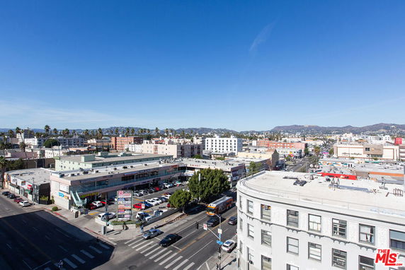 Panoramic view of a cityscape with multiple buildings and a clear blue sky.