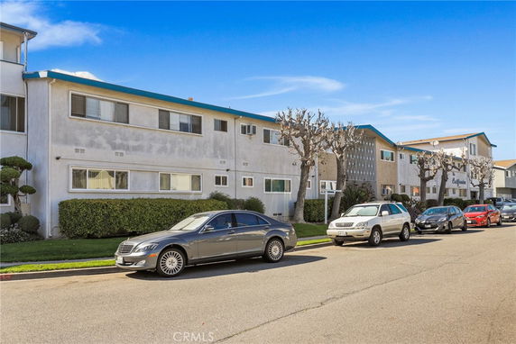 Front view of a two-story apartment building with multiple windows.