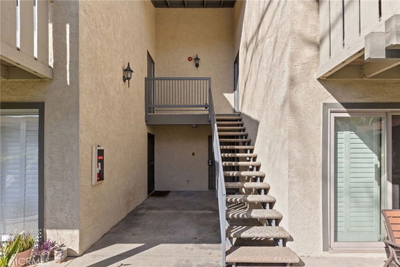 Exterior view showing stairs leading to the second floor of a building.