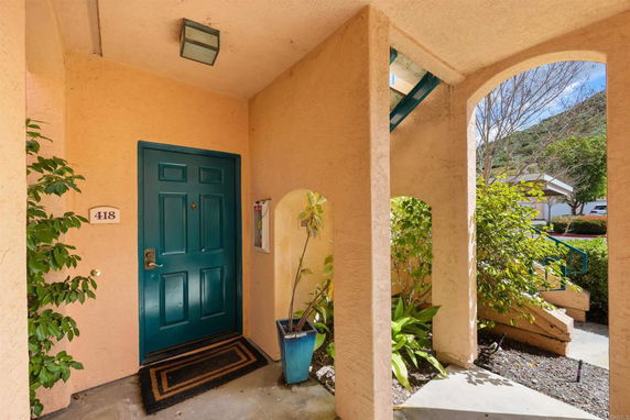 Front entrance of a house with a blue door and number 418.