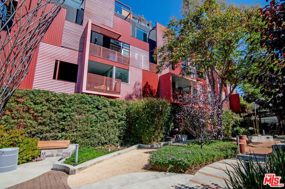 Front view of a multi-story apartment building with balconies.