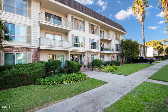 Front view of a multi-story residential building with balconies.