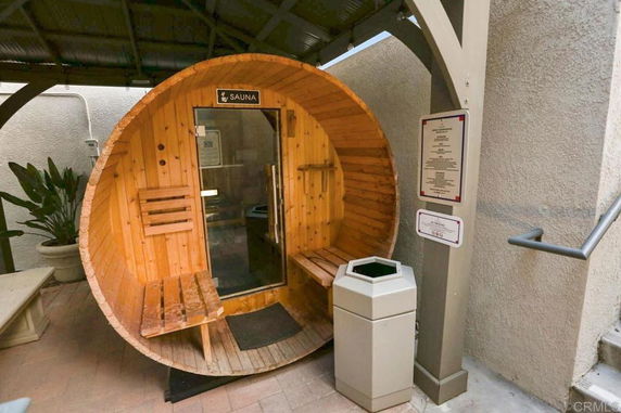 Wooden sauna installed in a covered indoor area.