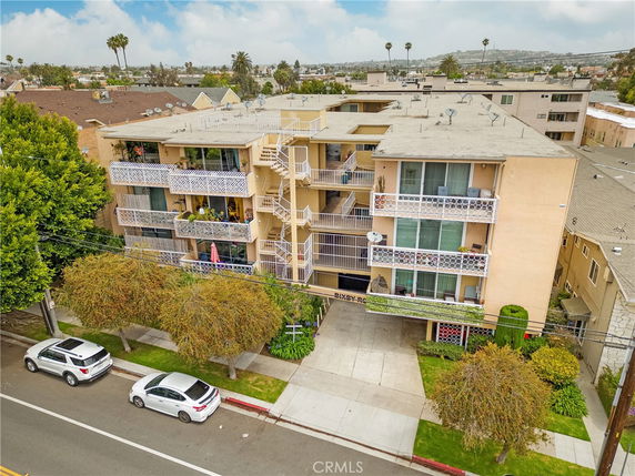 Front view of a multi-story apartment building with balconies.