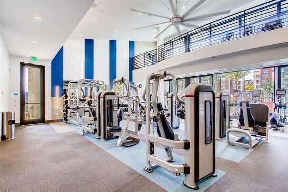 Interior of a modern gym with exercise machines and equipment.