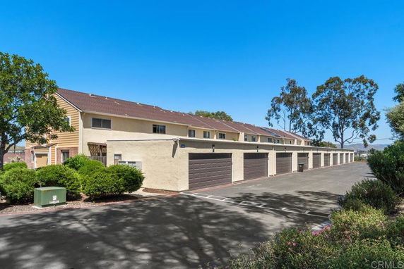 Front view of a two-story building with multiple garage units.