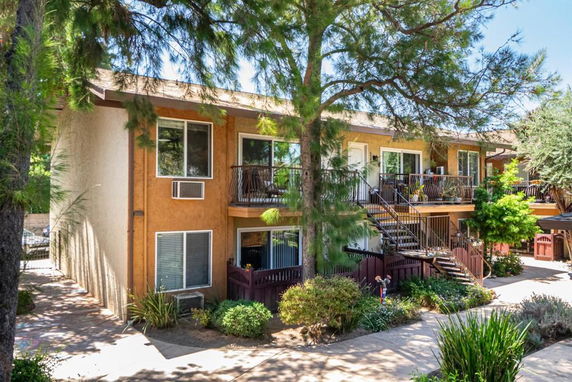 Front view of a two-story apartment building with exterior stairs and balconies.