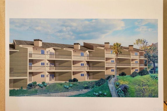Front view of a multi-story residential building with balconies.