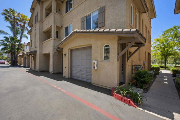 Front view of a multi-story building with attached garage.