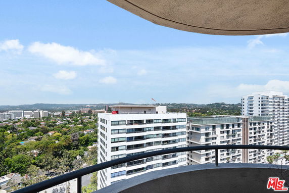 Panoramic view of surrounding buildings and landscape seen from a high vantage point.
