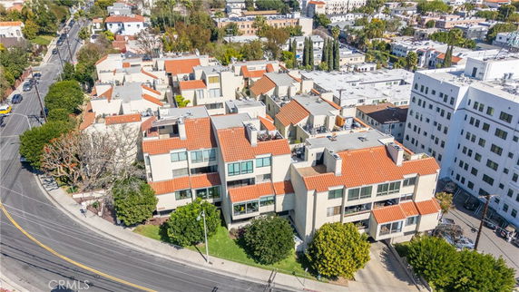 Aerial view of a residential area with multiple buildings featuring red-tiled roofs.