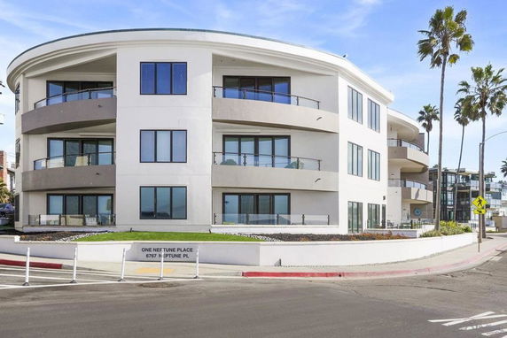 Front view of a modern multi-story building with balconies.