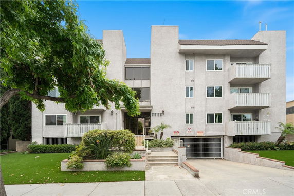 Front view of a multi-story residential building with balconies.