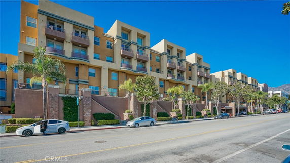 Front view of a multi-story residential building with balconies.