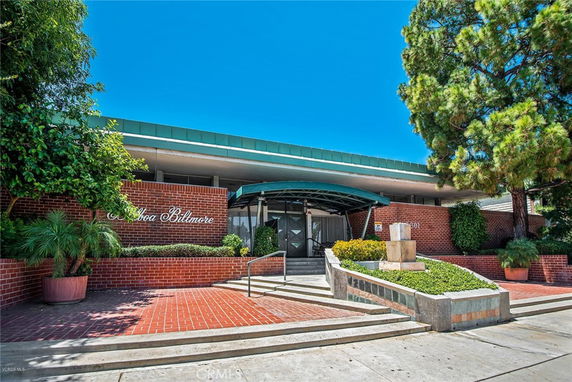 Front view of a building with a brick facade and canopy entrance.