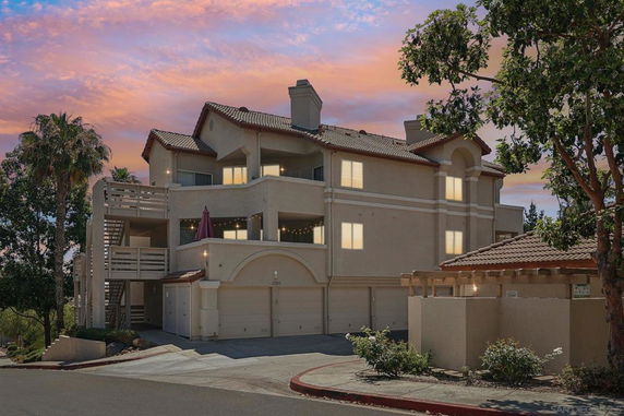 Front view of a multi-story apartment building with external staircases.