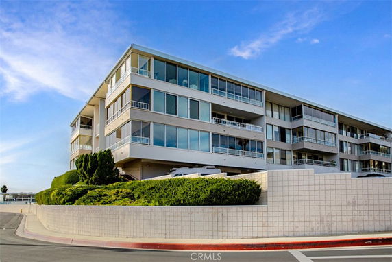 Front view of a multi-story building with large windows.