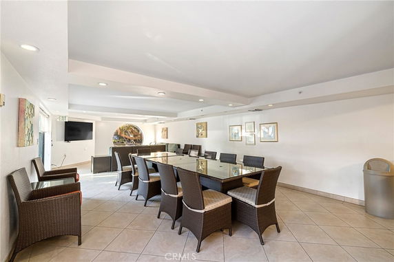 Interior view of a recreational room with a long table and chairs.