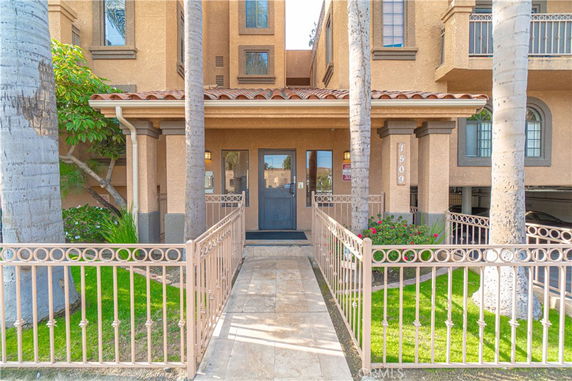 Front view of a building entrance with a gated walkway.