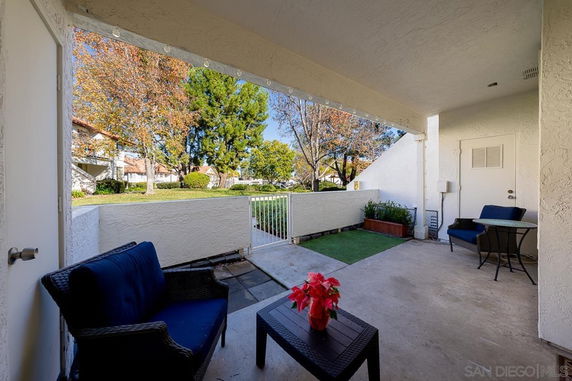 Outdoor patio area with seating overlooking a courtyard.