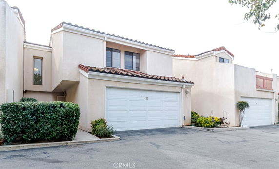 Front view of a two-story house with a tiled roof and double garage.