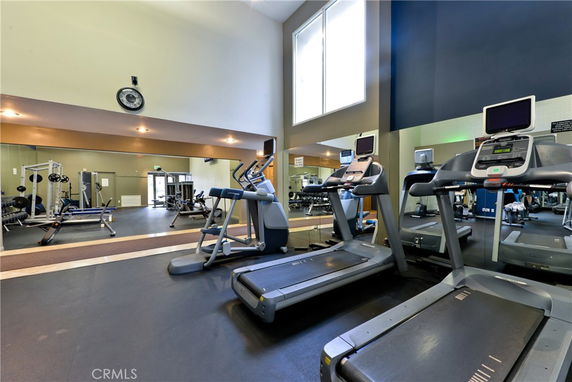 Indoor gym area with treadmills and weightlifting equipment.