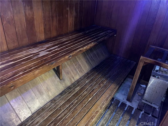 Interior of a wooden sauna with benches and a heater.