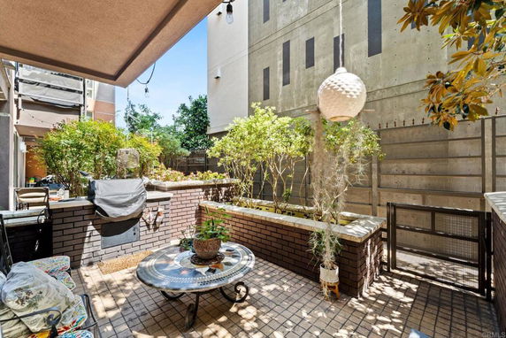 Outdoor patio area with brick walls and plants.