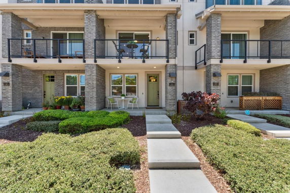 Front view of a multi-story residential building with balconies.