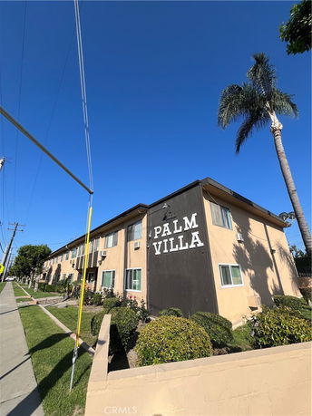 Front view of a multi-story building labeled 'Palm Villa'.