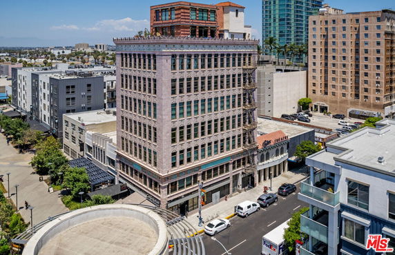 Front view of a tall, multi-story building with large windows.