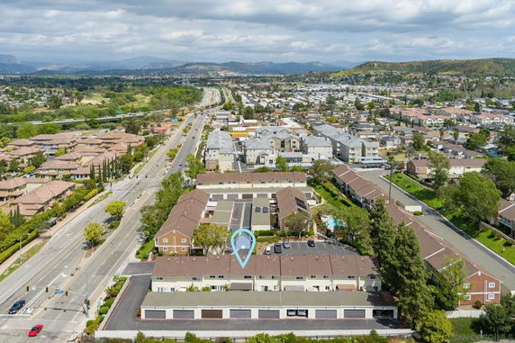 Aerial view of residential neighborhood with rows of houses and roads.