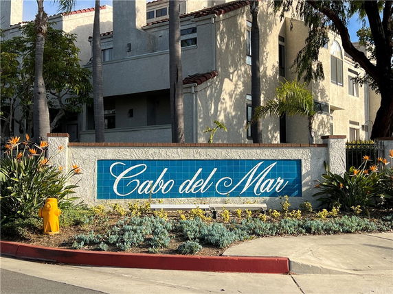 Front view of a multi-story residential building with a sign reading 'Cabo del Mar'.