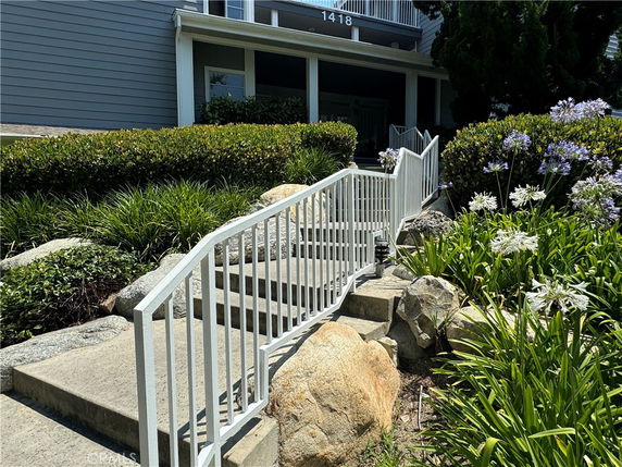 Front view of a house with steps leading up to the entrance.