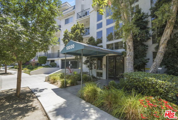 Front view of a multi-story building with entrance canopy.
