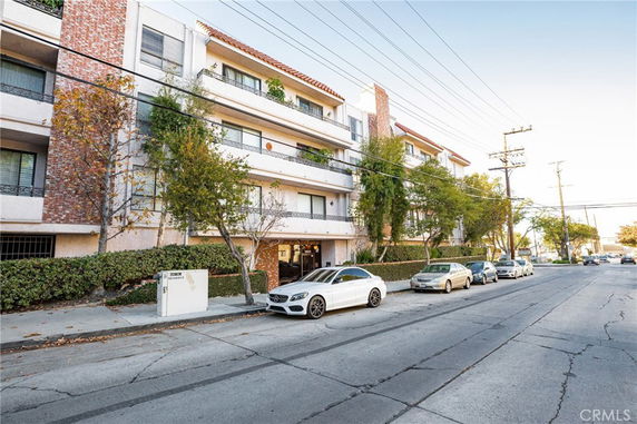 Front view of a multi-story apartment building with balconies.