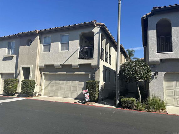 Front view of a multi-story house with a double garage.