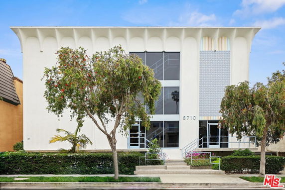 Front view of a modern two-story building with large windows.