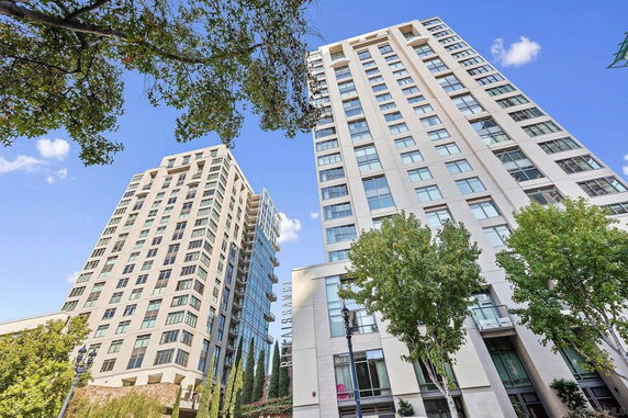Front view of two multi-story buildings with numerous windows.