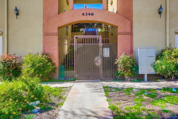 Front view of a building entrance with a gated archway.