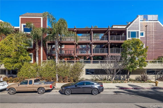 Front view of a multi-story building with balconies.