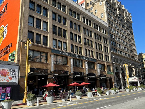 Elevation view of a multi-story commercial building with outdoor seating.