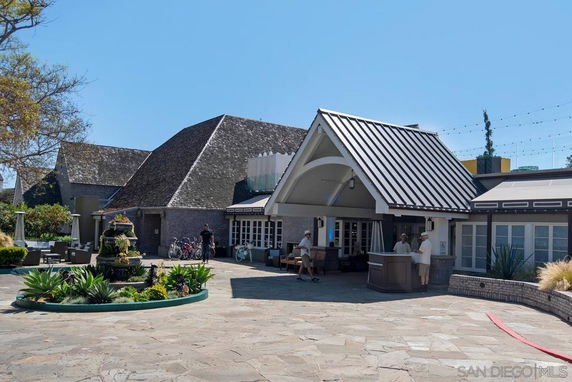 Front view of a building with a wide, sloped roof and covered entrance.