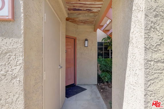 Entrance view of a house with a covered entryway and a door.
