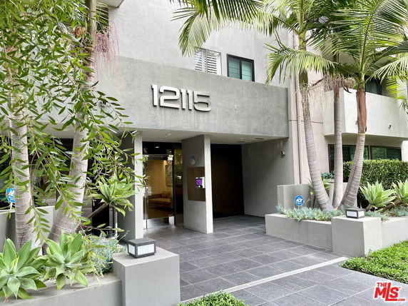 Front view of a building entrance with the number 12115 displayed prominently.
