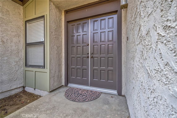 Front view of a house entrance with a double door.