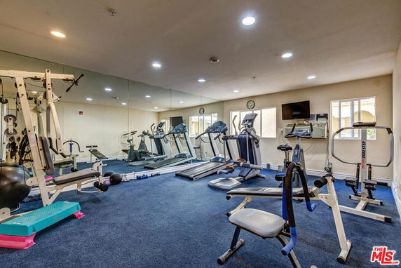 Indoor gym area with various exercise equipment.