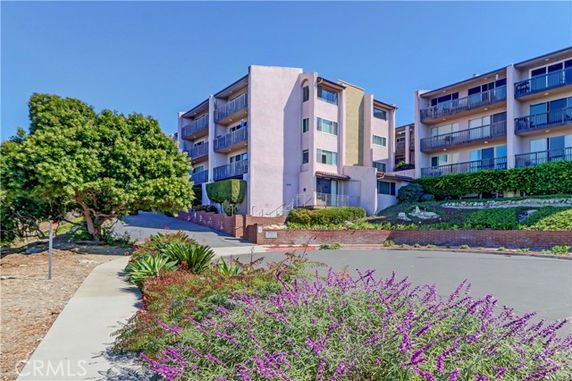 Front view of a multi-story residential building with balconies.